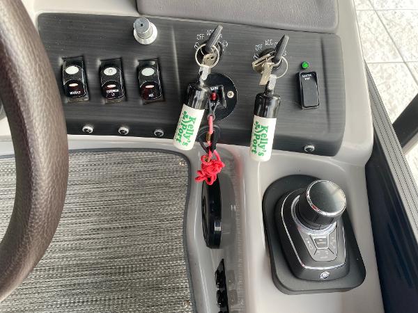 Slide: The Image of Control panel of a 2020 Bennington 30 QSBAX2 boat with keys and switches. - 42