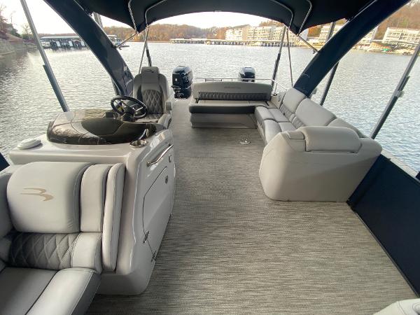 Slide: The Image of 2020 Bennington 30 QSBAX2 pontoon boat interior with luxurious seating on a calm lake. - 47