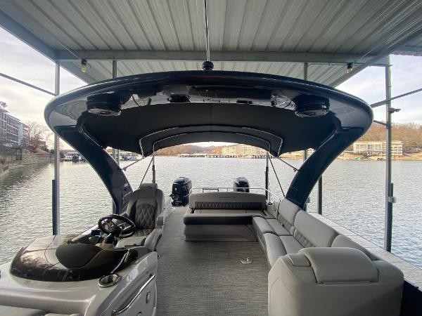 Slide: The Image of 2020 Bennington 30 QSBAX2 pontoon boat with spacious seating under a covered dock. - 48
