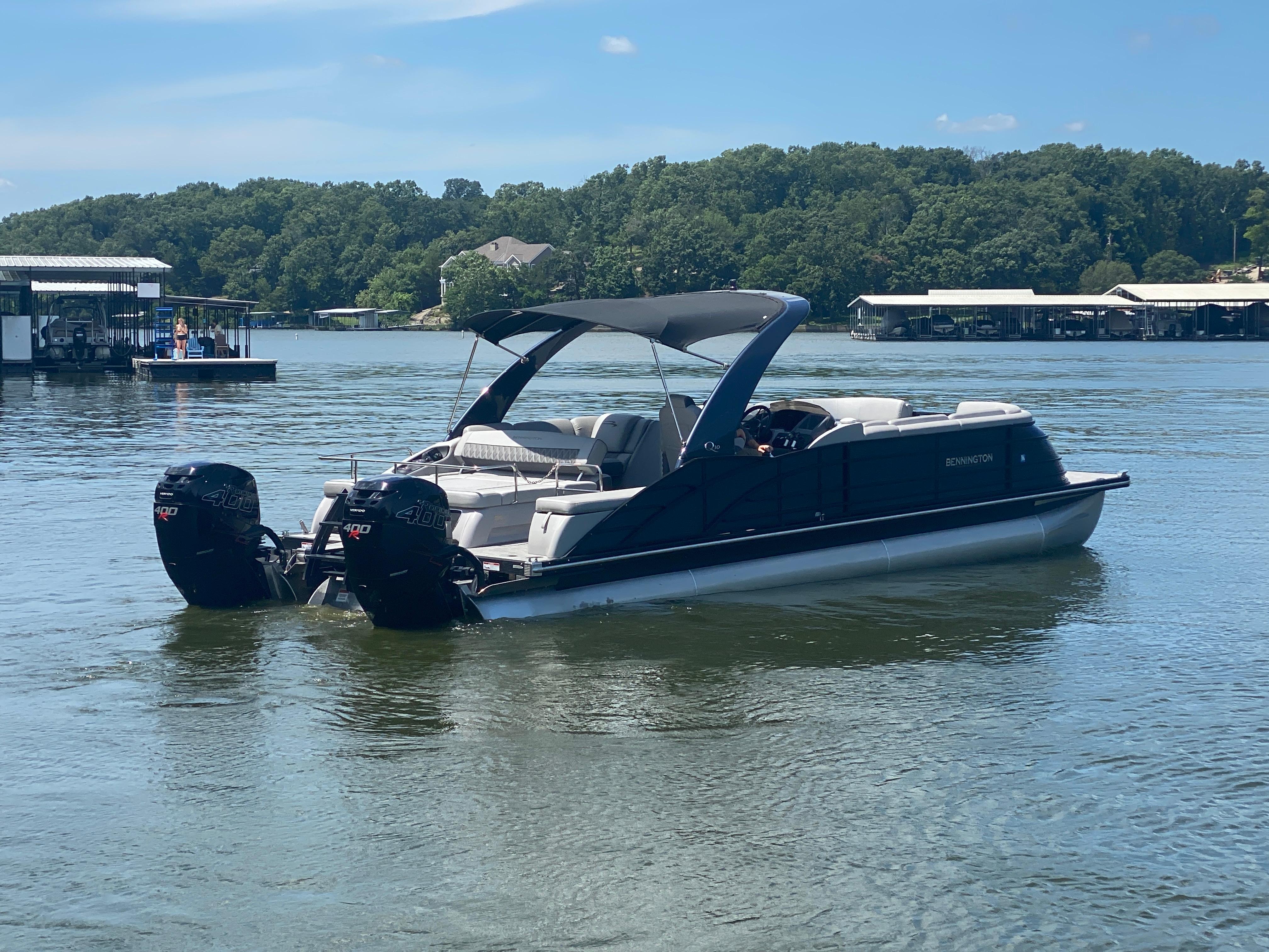 Slide: The Image of 2020 Bennington 30 QSBAX2 pontoon boat on a serene lake. - 7