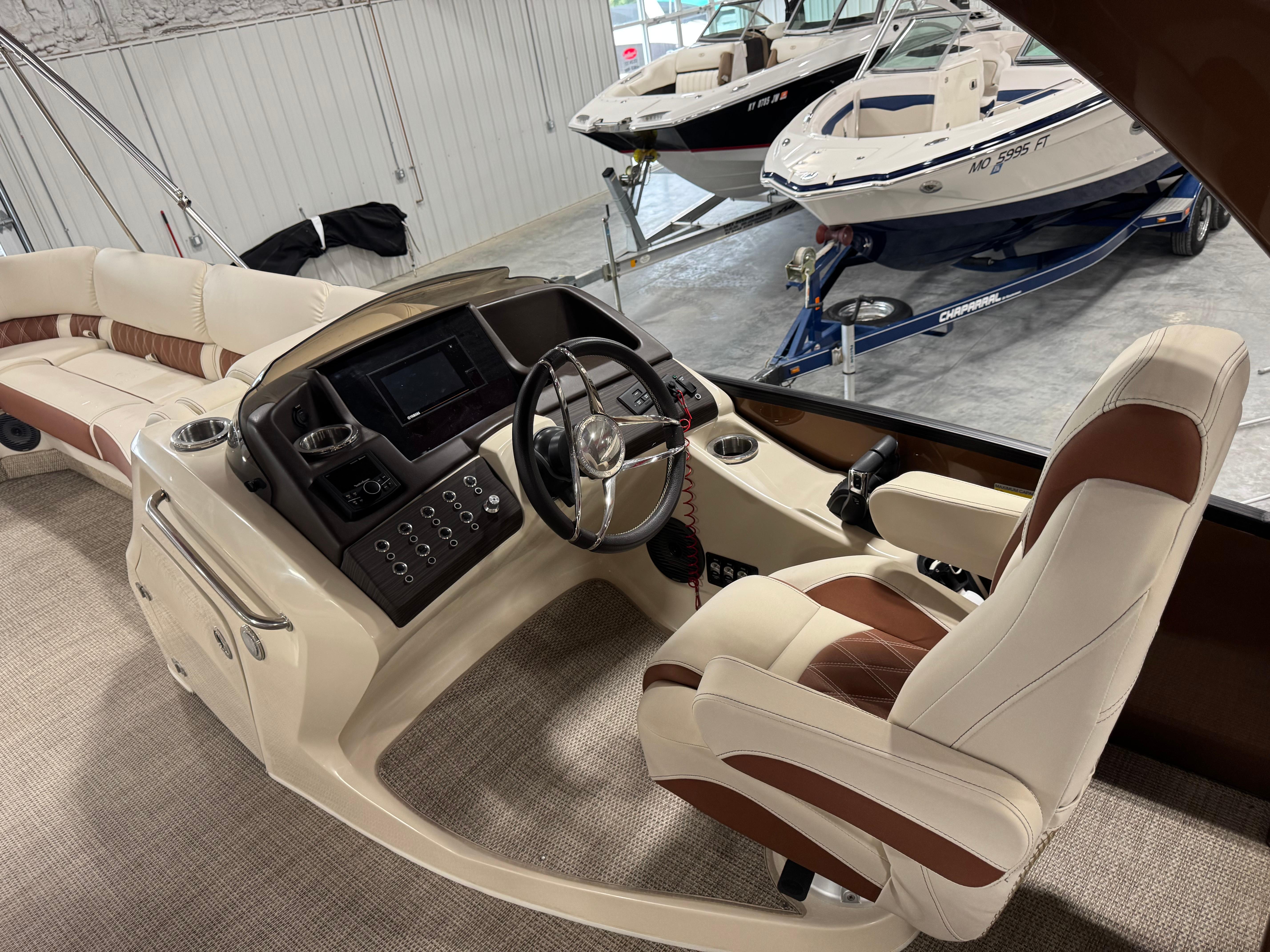 Slide: The Image of 2022 Bennington QX 30 boat interior with luxurious seating and modern dashboard controls. - 11