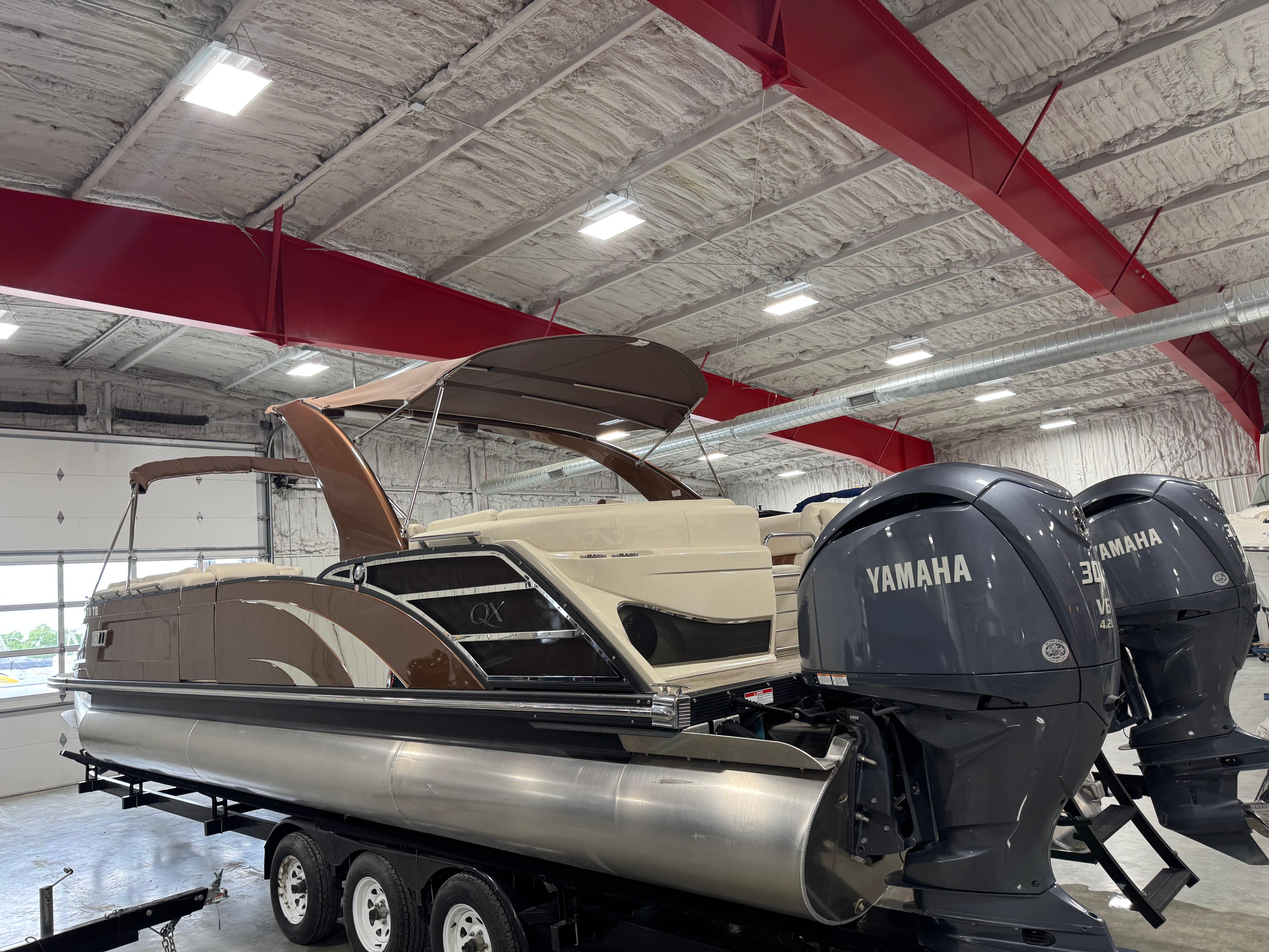Slide: The Image of 2022 Bennington QX 30 pontoon boat with Yamaha engines in a showroom. - 3
