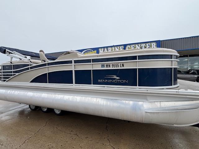 Slide: The Image of 2017 Bennington R23 pontoon boat parked at a marine center. - 2