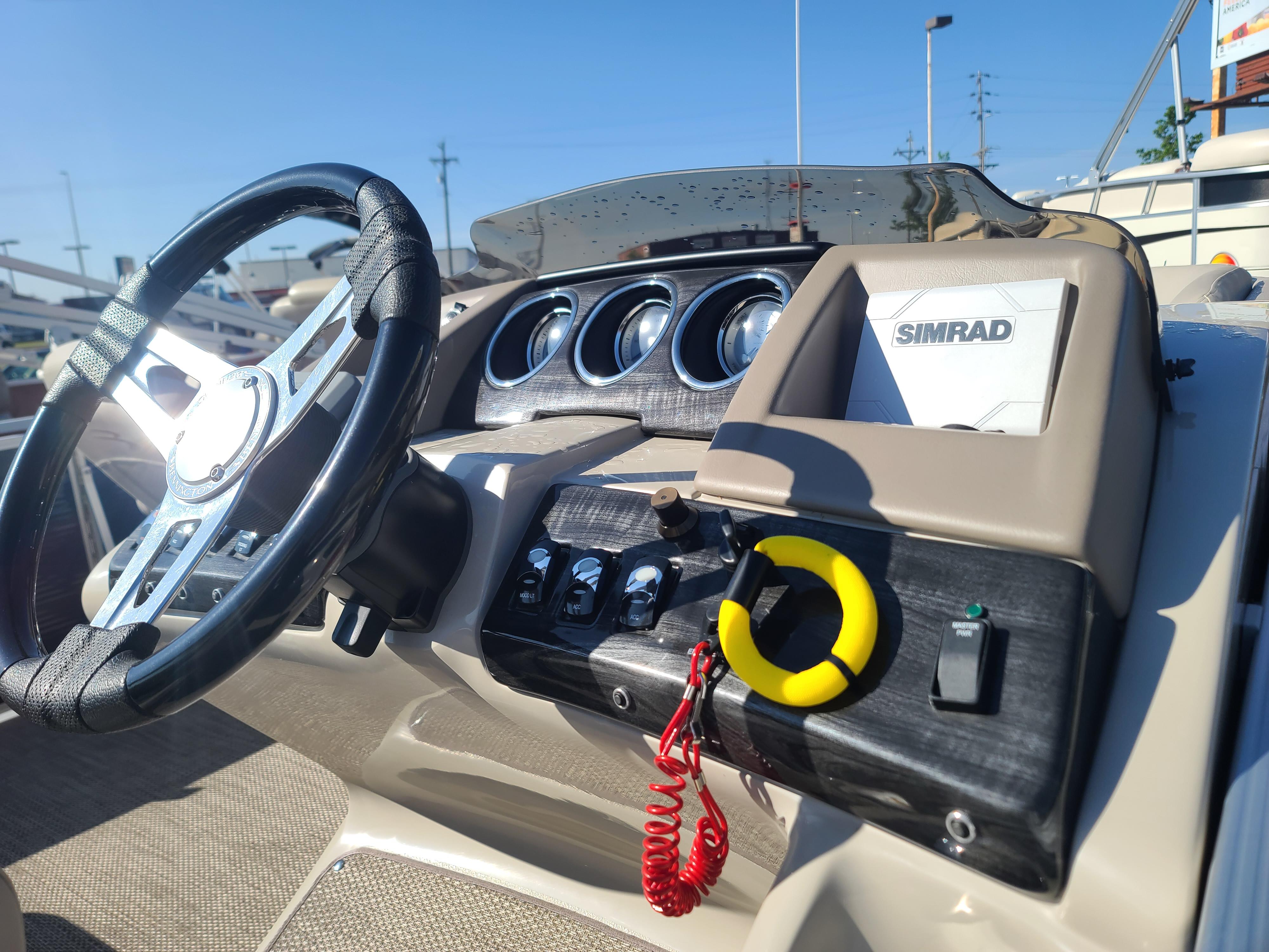 Slide: The Image of 2017 Bennington R23 boat dashboard with steering wheel and Simrad navigation system. - 7
