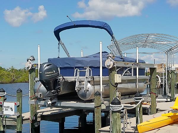 Slide: The Image of 2020 Bennington SV 20 SLV pontoon boat docked with Yamaha outboard motor. - 10