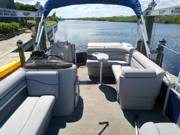 Slide: The Image of 2020 Bennington SV 20 SLV pontoon boat with spacious seating on a serene waterway. - 12