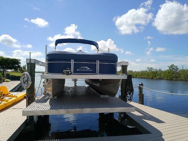 Slide: The Image of 2020 Bennington SV 20 SLV pontoon boat on dock under blue sky. - 2