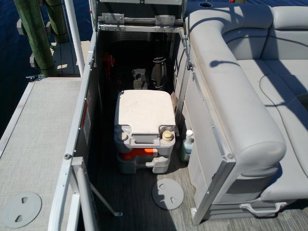 Slide: The Image of 2020 Bennington SV 20 SLV boat storage area with cooler and seating. - 27