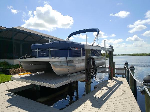 Slide: The Image of 2020 Bennington SV 20 SLV pontoon boat docked by a scenic waterfront. - 3