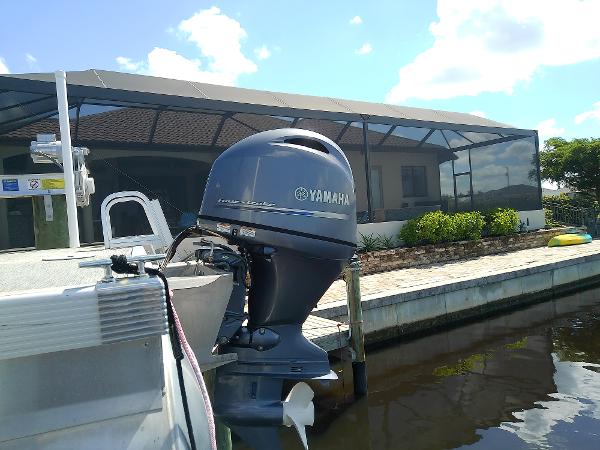 Slide: The Image of 2020 Bennington SV 20 SLV pontoon boat with Yamaha outboard motor docked by a canal. - 5