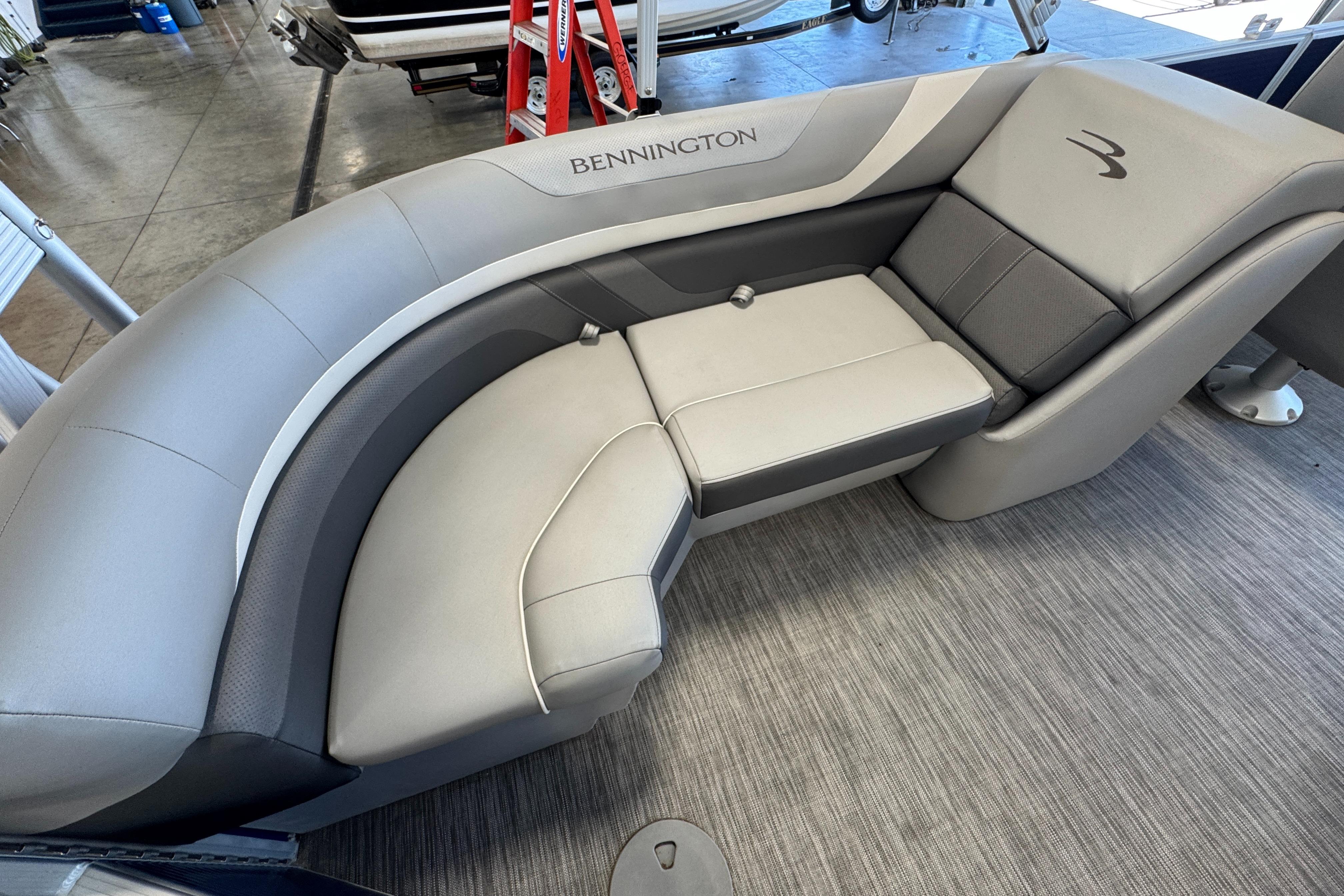 Slide: The Image of 2020 Bennington SX 22 SSRX boat interior with gray cushioned seating. - 14