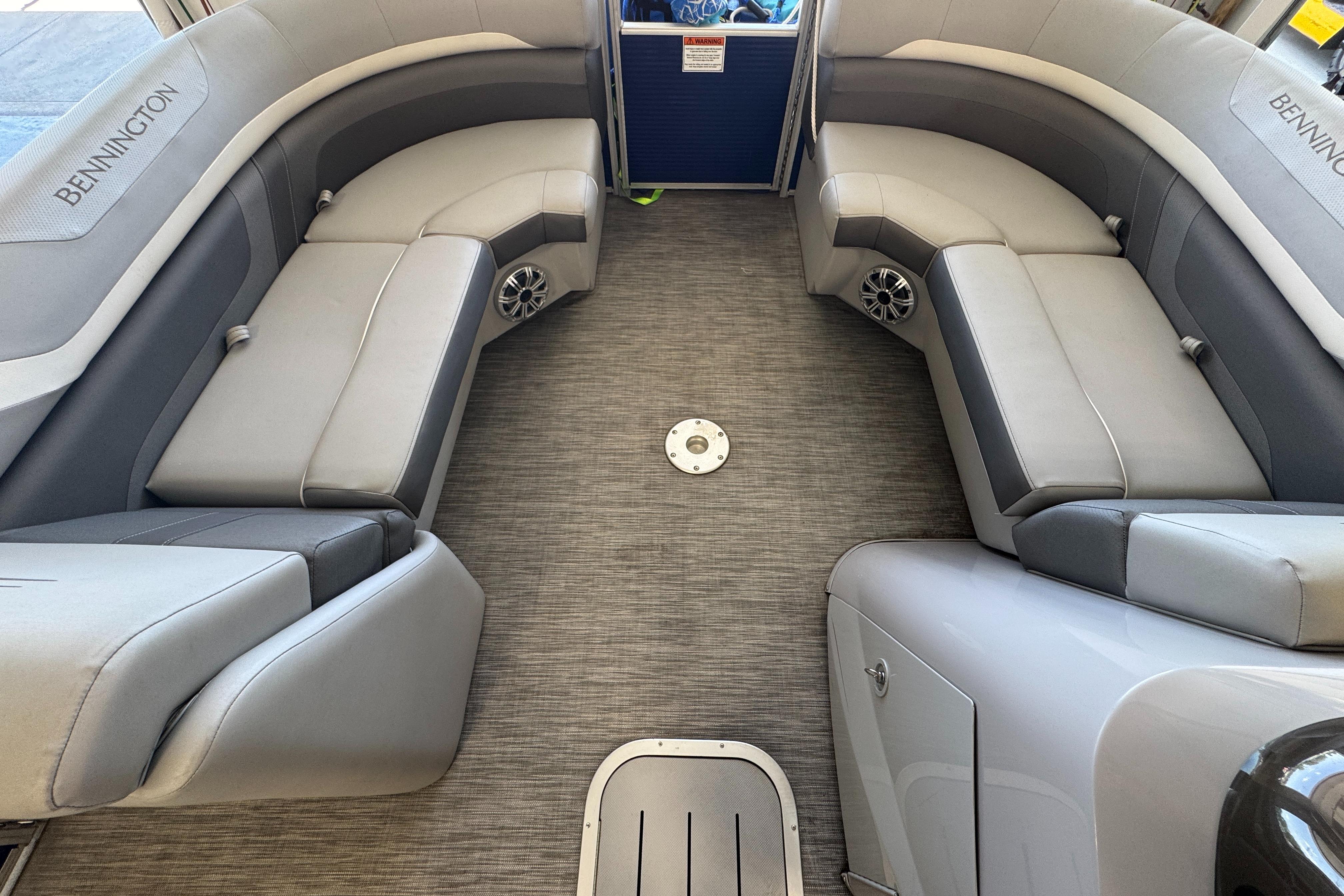 Slide: The Image of 2020 Bennington SX 22 SSRX boat interior with gray seating and carpeted floor. - 16