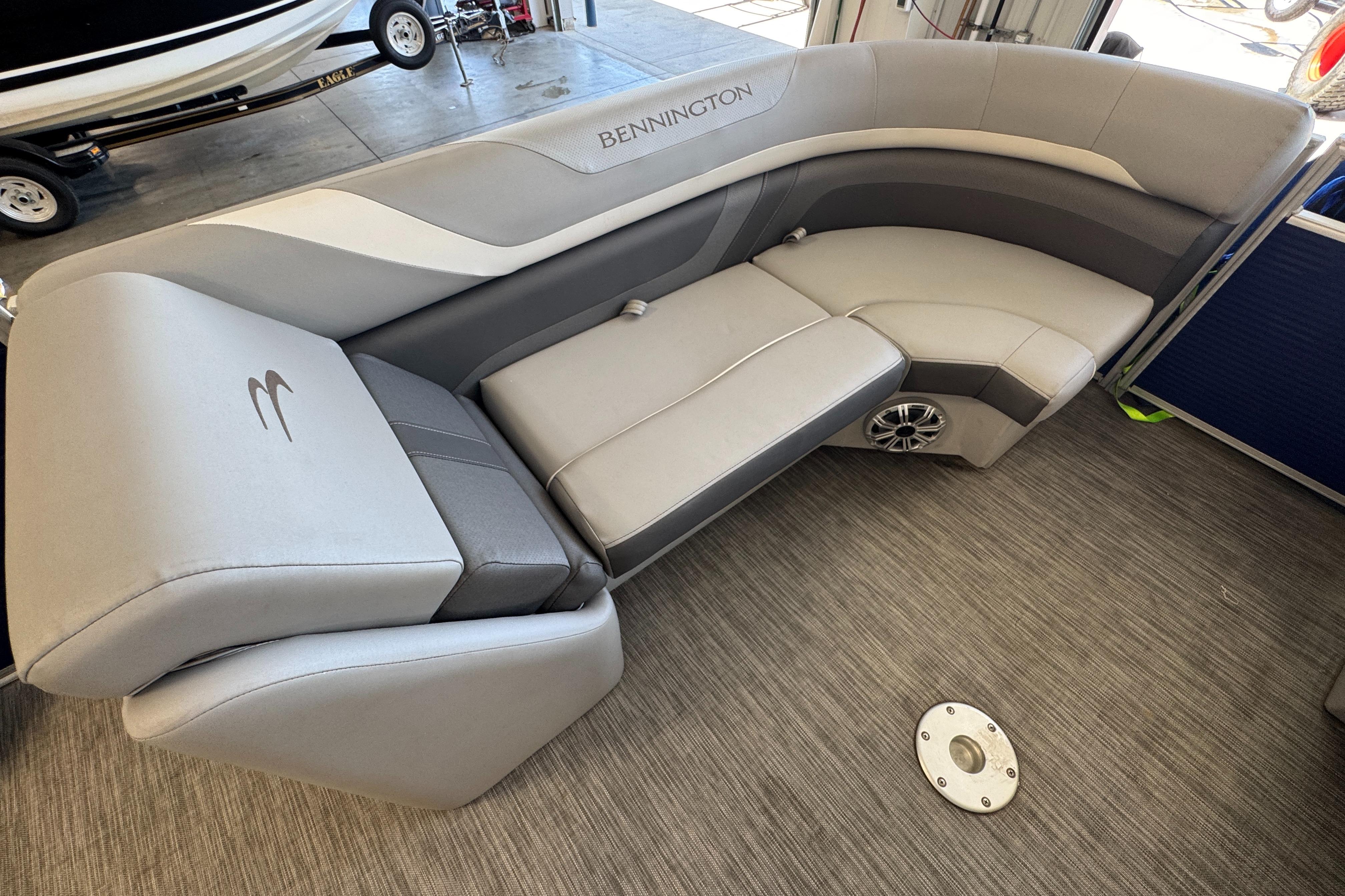 Slide: The Image of 2020 Bennington SX 22 SSRX boat interior with gray seating and speaker. - 17