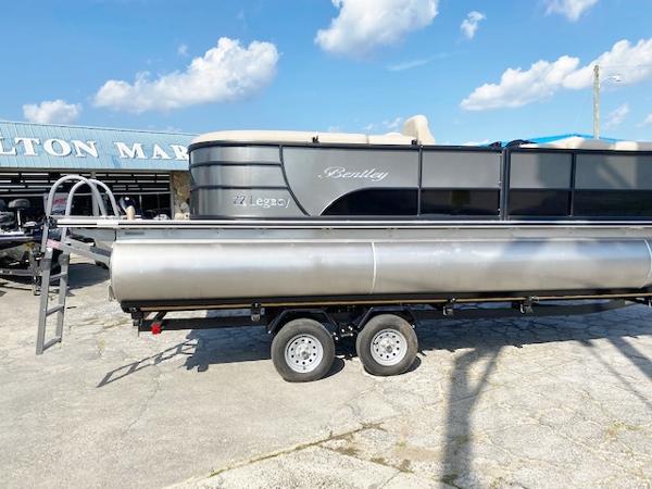 Slide: The Image of 2024 Bentley Pontoons 220 Legacy Navigator on trailer at marina. - 3