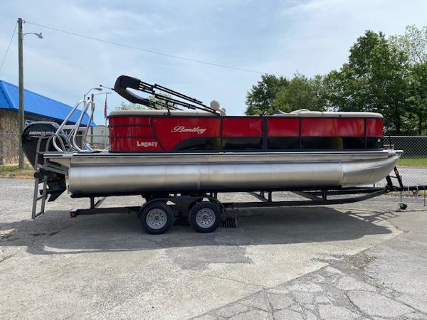 Slide: The Image of 2023 Bentley Pontoons 220 Navigator on trailer, red and silver, side view. - 1