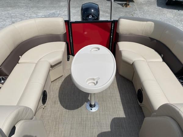 Slide: The Image of 2023 Bentley Pontoons 220 Navigator interior with beige seating and round table. - 2