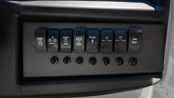 Slide: The Image of Control panel of the 2024 Bentley Pontoons 240 Navigator with various switches. - 11
