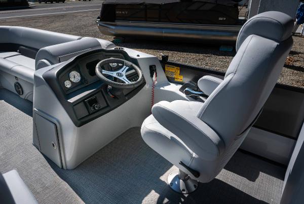Slide: The Image of 2024 Bentley Pontoons 240 Navigator boat interior with captain's chair and steering console. - 9