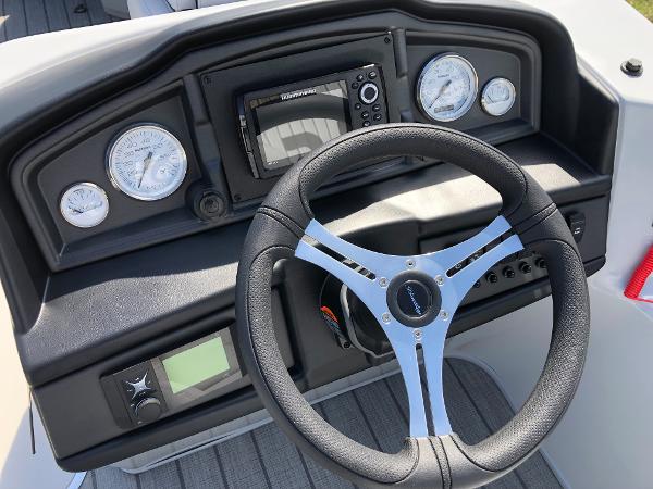 Slide: The Image of 2023 Bentley Pontoons Legacy 223 Navigator dashboard with steering wheel and gauges. - 10