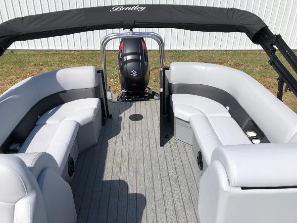 Slide: The Image of 2023 Bentley Pontoons Legacy 223 Navigator interior with seating and outboard motor. - 6