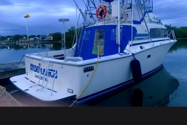Slide: The Image of 1980 Bertram 33 Sport Fisherman docked at a marina. - 0