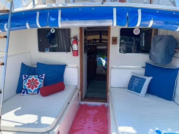 Slide: The Image of 1980 Bertram 33 Sport Fisherman boat interior with blue and white cushions. - 16