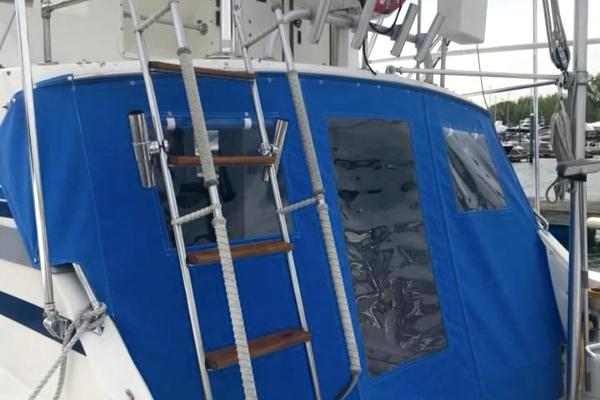 Slide: The Image of 1980 Bertram 33 Sport Fisherman with blue canvas cover and ladder. - 4