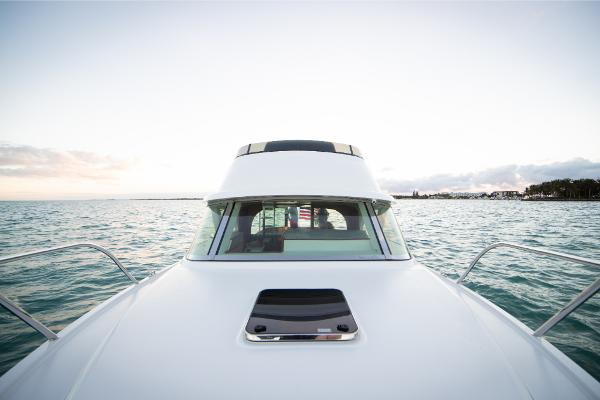 Slide: The Image of 2023 Bertram 35 Flybridge yacht on open water, front view. - 10