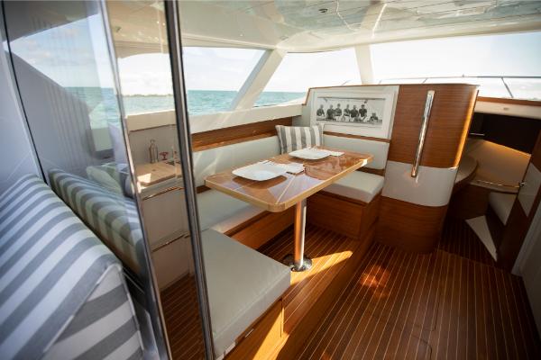 Slide: The Image of Interior of 2023 Bertram 35 Flybridge yacht with dining area and ocean view. - 15