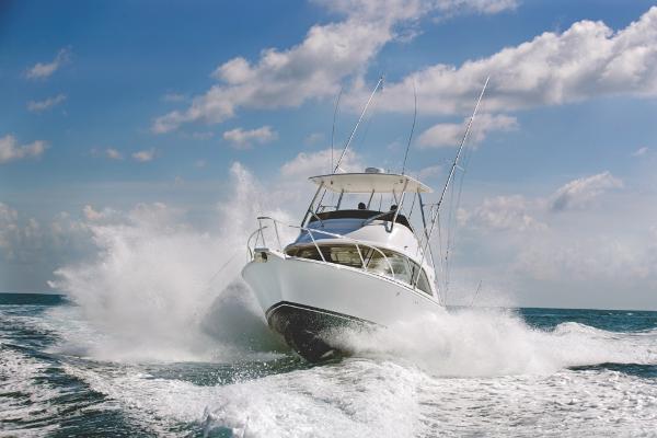 Slide: The Image of 2023 Bertram 35 Flybridge boat cruising on open water. - 2