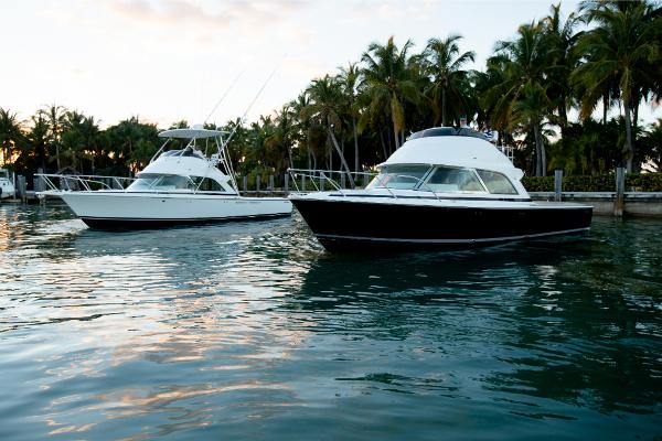 Slide: The Image of Two 2023 Bertram 35 Flybridge boats docked near palm trees. - 20