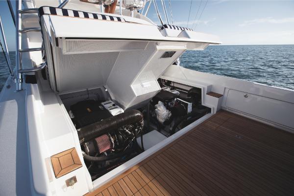 Slide: The Image of 2023 Bertram 35 Flybridge engine compartment with open hatch, showcasing marine engines. - 22