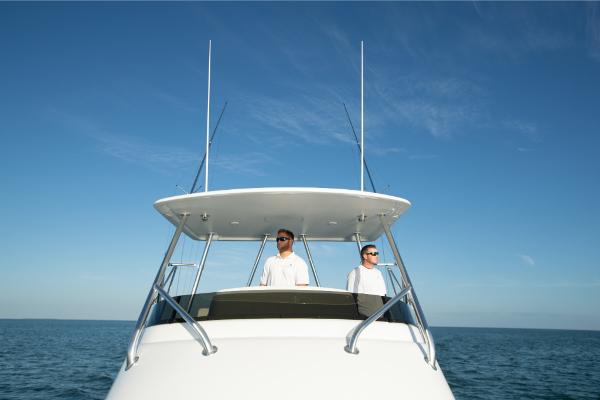 Slide: The Image of 2023 Bertram 35 Flybridge boat with two people on the flybridge. - 25