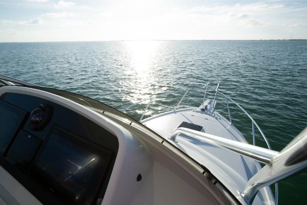 Slide: The Image of 2023 Bertram 35 Flybridge cruising on open water at sunset. - 28