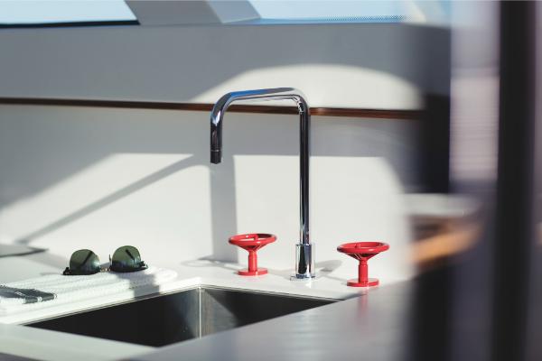 Slide: The Image of Modern kitchen sink on 2023 Bertram 35 Flybridge yacht with sleek faucet and red handles. - 3