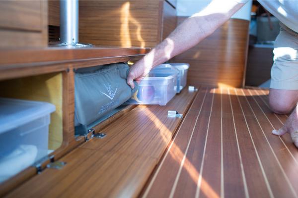 Slide: The Image of Man organizing storage compartment on 2023 Bertram 35 Flybridge boat. - 32