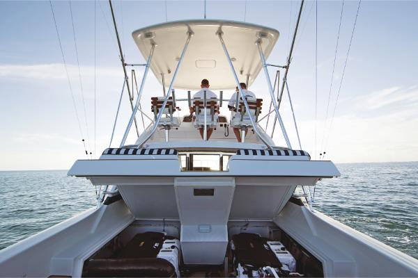 Slide: The Image of 2023 Bertram 35 Flybridge yacht on open water, rear view. - 36