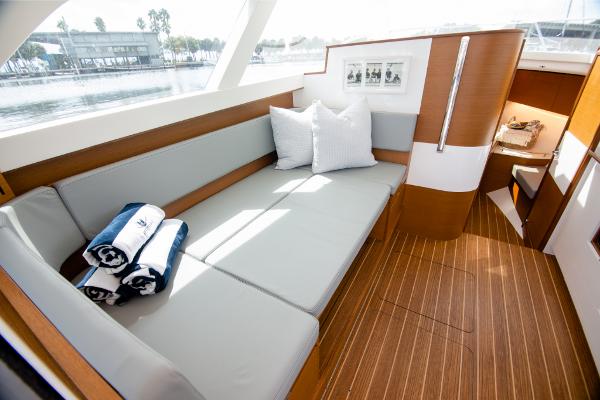 Slide: The Image of 2023 Bertram 35 Flybridge interior with cushioned seating and wooden flooring. - 7