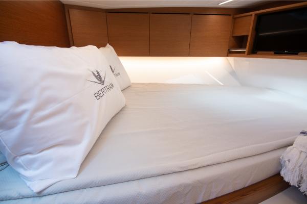 Slide: The Image of Luxurious cabin interior of 2023 Bertram 35 Flybridge yacht with cozy bedding. - 9