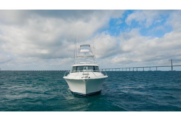 Slide: The Image of 2023 Bertram 50 Sport yacht on open water with bridge in background. - 10