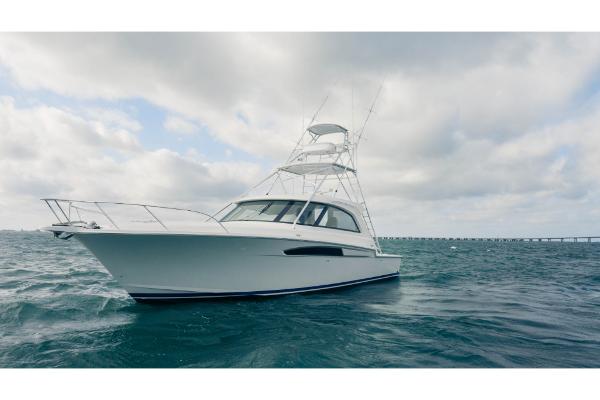 Slide: The Image of 2023 Bertram 50 Sport yacht on open water under cloudy sky. - 11
