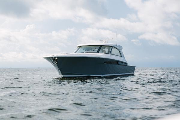 Slide: The Image of 2023 Bertram 50 Sport yacht cruising on open water. - 19