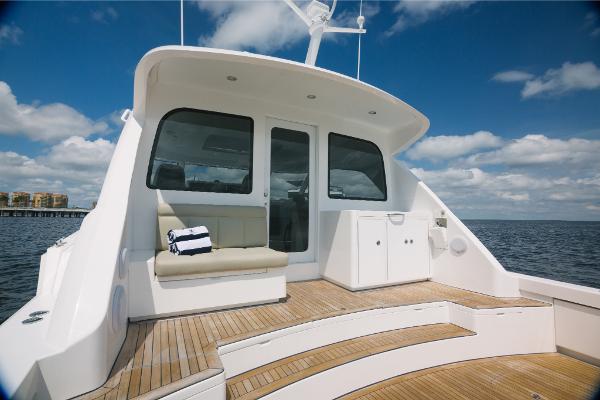 Slide: The Image of 2023 Bertram 50 Sport yacht with spacious deck and seating area. - 20