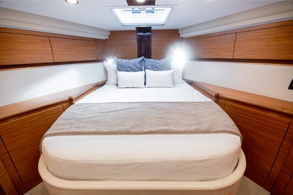 Slide: The Image of Luxurious bedroom interior of 2023 Bertram 50 Sport yacht with modern wood finishes. - 21