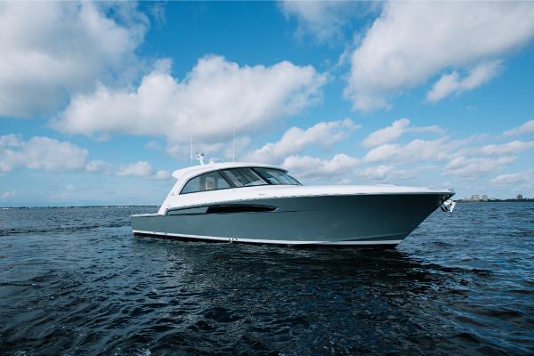 Slide: The Image of 2023 Bertram 50 Sport yacht cruising on open water under a blue sky. - 22