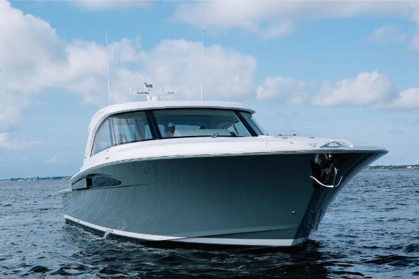 Slide: The Image of 2023 Bertram 50 Sport yacht cruising on open water. - 23