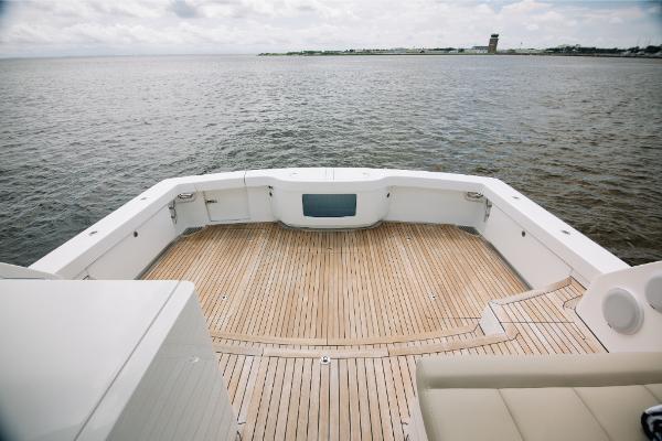 Slide: The Image of Bertram 50 Sport 2023 yacht with spacious teak deck overlooking calm waters. - 25