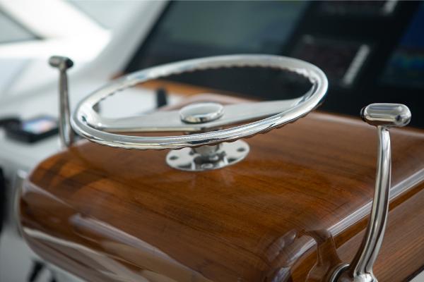 Slide: The Image of Steering wheel of 2023 Bertram 50 Sport yacht with wooden console. - 35