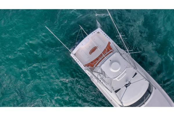 Slide: The Image of Aerial view of 2023 Bertram 50 Sport yacht on turquoise water. - 4