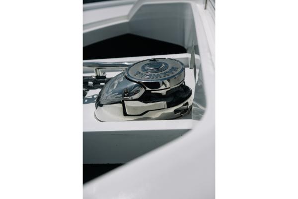 Slide: The Image of Close-up of the anchor winch on a 2023 Bertram 50 Sport boat. - 48